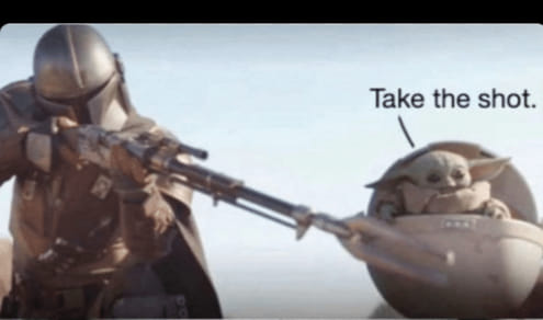 This meme is a still image from the Star Wars franchise, specifically from the TV series "The Mandalorian". In the image, the Mandalorian (a character from the show) is holding a young creature known as "The Child" (also called "Baby Yoda") in his arms. The text "Take the shot" is written above the image, implying that the Mandalorian should shoot at something, but the image is actually a joke and the "shot" is actually a reference to a popular internet meme where someone says "take the shot" in a situation where you should just go for it and do something.